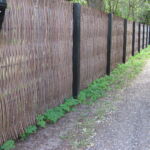 Det smukke lodrette pilehegn opført med pilesorten Engelsk Viminalis flette over rundstokke i jern omkranser hele grunden i Liseleje.