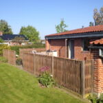 Lodret pilehegn med flere udgange til haven.